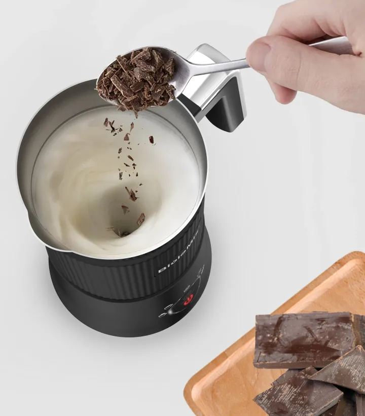 A woman models a black Tiny Spark hoodie with a vibrant graphic print, red sunglasses, and a silver chain, ideal for street style collections.